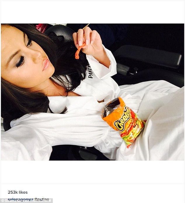 Selena Gomez shares photo where she's snacking on Flaming Hot Cheetos amid weight criticism | Daily Mail Online